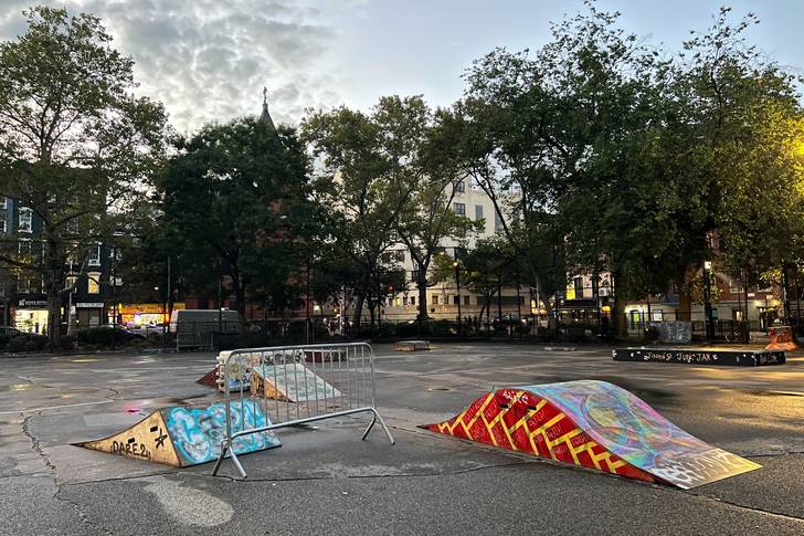 A collection of ramps, boxes, and other objects brought by skaters to the multipurpose court in Tompkins Square Park.
